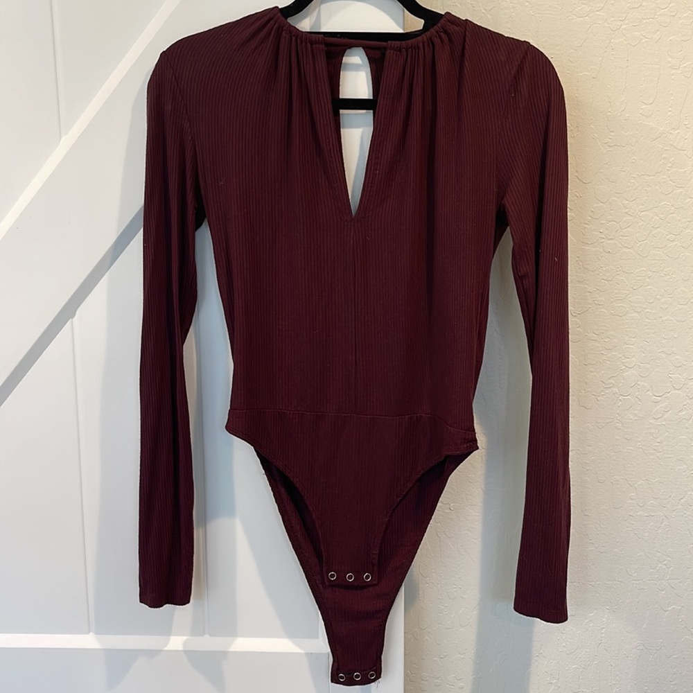 Ribbed long sleeve body suit with cut out